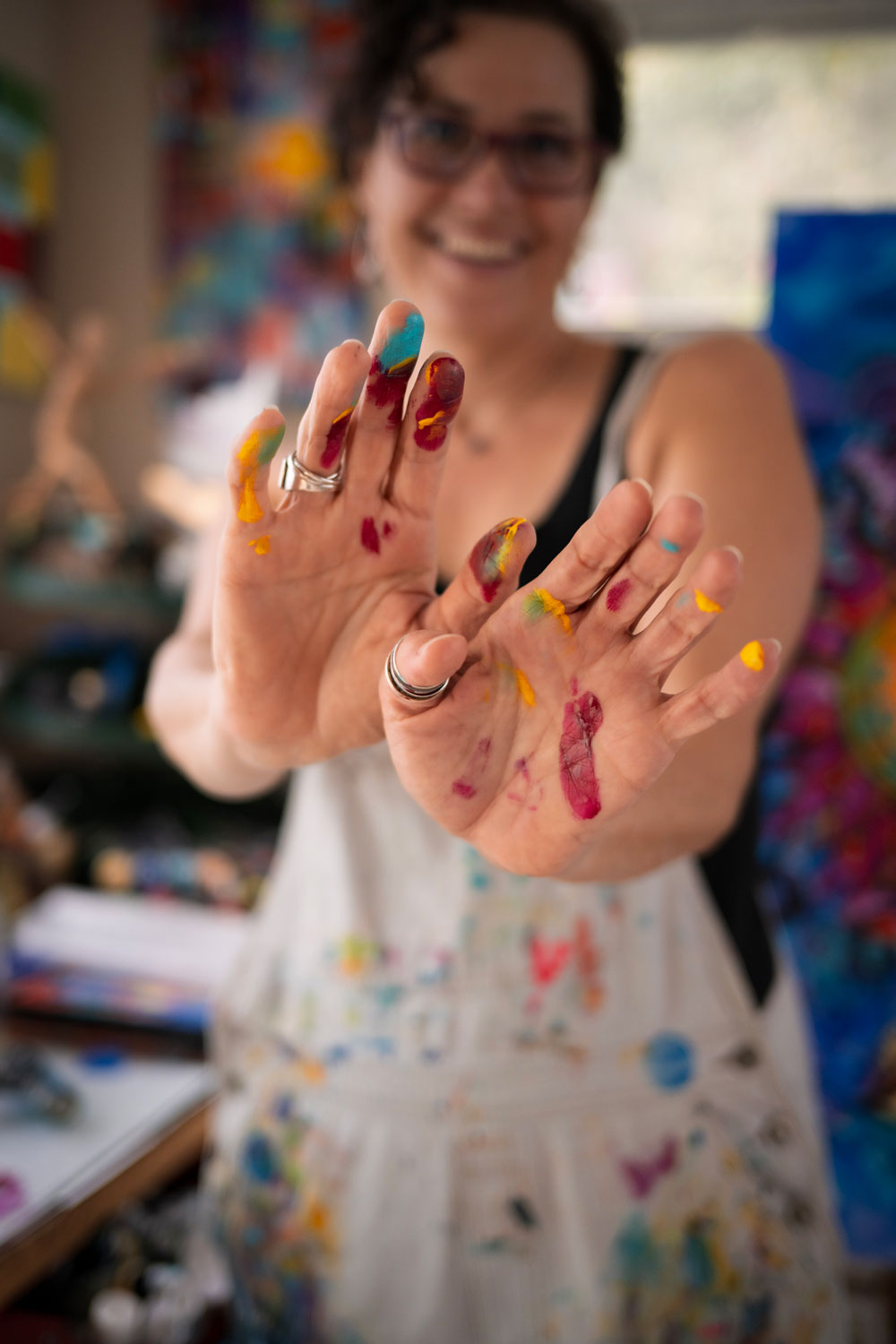 artist with Hands out and paint on fingers